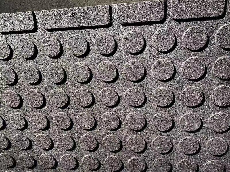 A detailed diagram showing the layers and composition of a gym floor tile